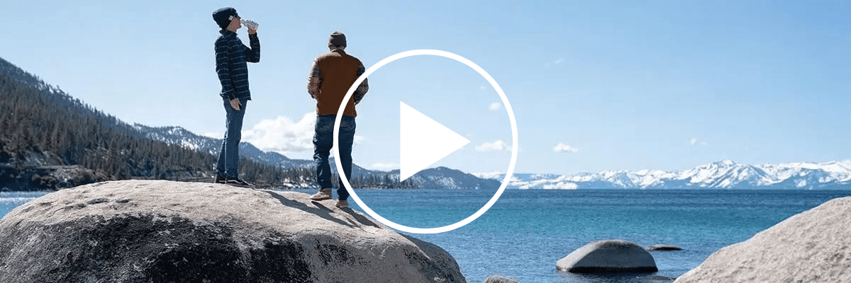 Couple drinking water on the rocks